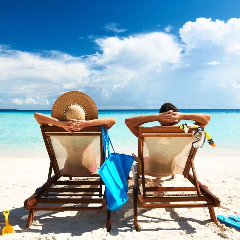 couple in beach lounges